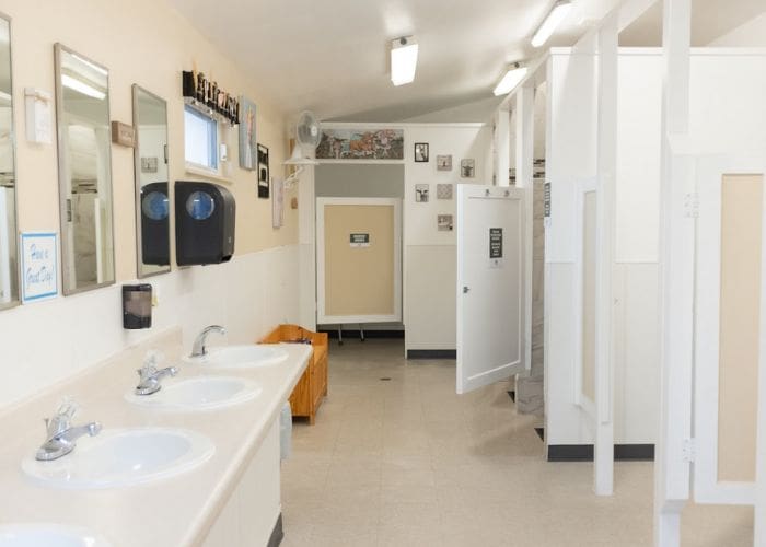 Interior view of sinks and shower room stalls at Southern Hills RV Park and Campground
