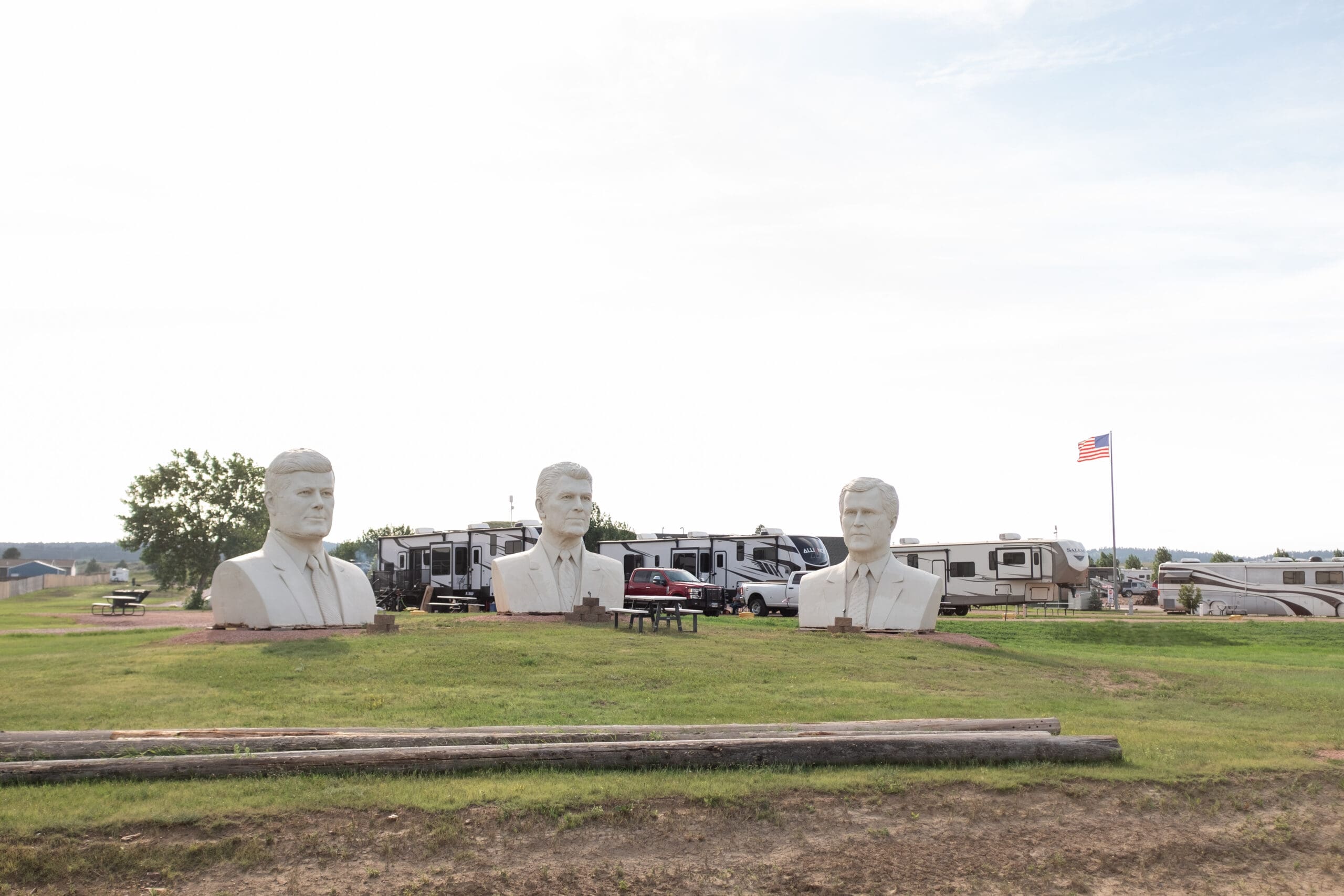 Southern Hills RV Park and Campground with three minature presidental busts and an the American flag in the background